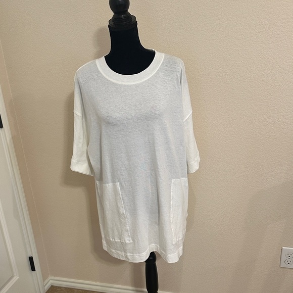 free people movement Tops - White/Ivory Free people Top with pockets! This t shirt is about mid thigh!